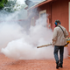 A mosquito control worker spraying a home in Wynwood on August 1st. Image:AP